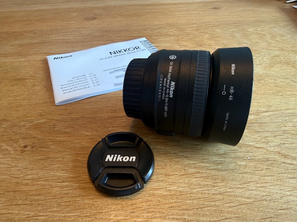 Nikon AF-S DX Nikkor 35mm f/1.8G + originele HB-46 zonnekap, Audio, Tv en Foto, Fotografie | Lenzen en Objectieven, Beschermhoes/tas