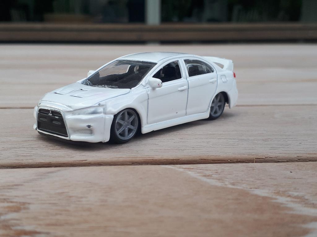 Burago Mitsubishi Lancer Evo kleine schaal wit, Ophalen of Verzenden, Zo goed als nieuw, Auto