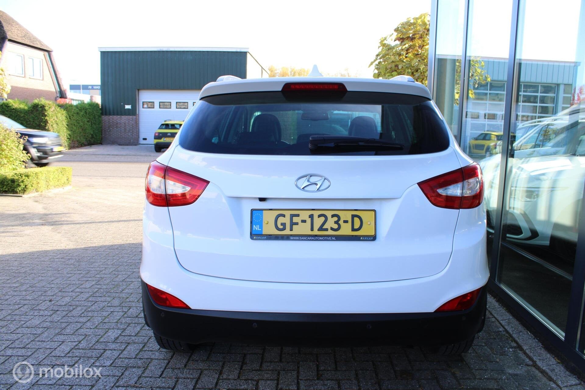 Hyundai ix35 1.6i GDI Go! Camera|Navi|Half-leder|NL-Auto, Auto's, Voorwielaandrijving, Euro 5, 4 cilinders, Wit