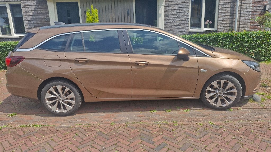 Opel Astra 1.0 Turbo 77KW Sports Tourer 2016 Bruin, Auto's, Voorwielaandrijving, Stof, Euro 6, 1178 kg