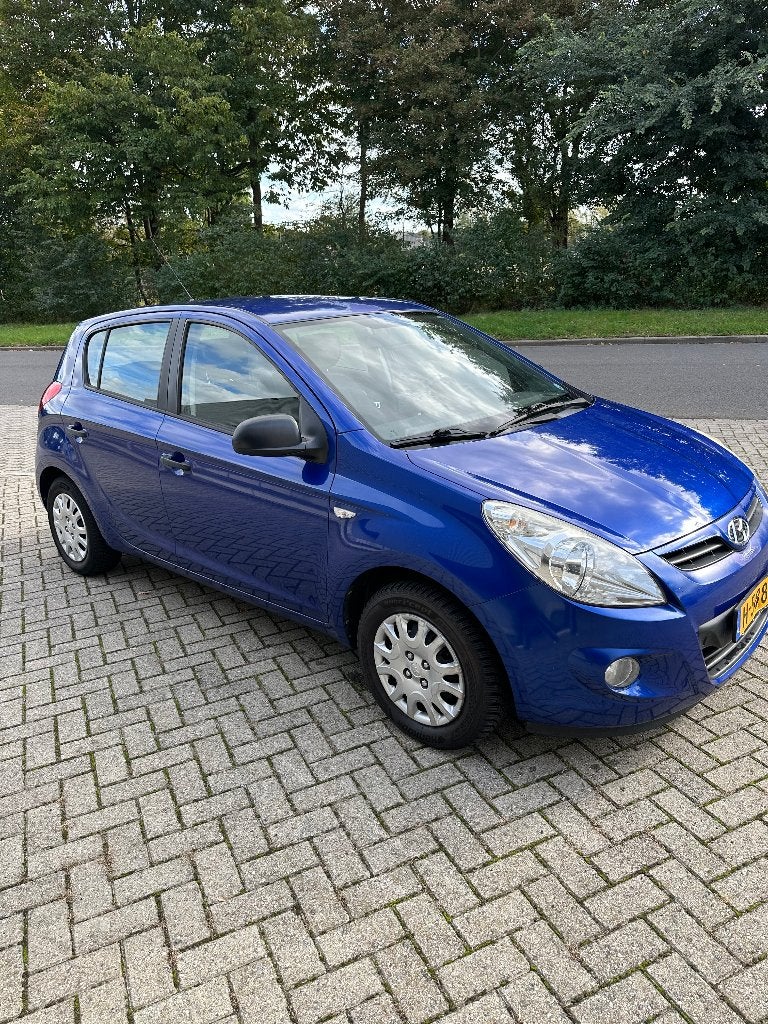 Hyundai i20 1.2 5-DRS 2009 Blauw met LPG, Auto's, Stof, 31 €/maand, 4 cilinders, Blauw