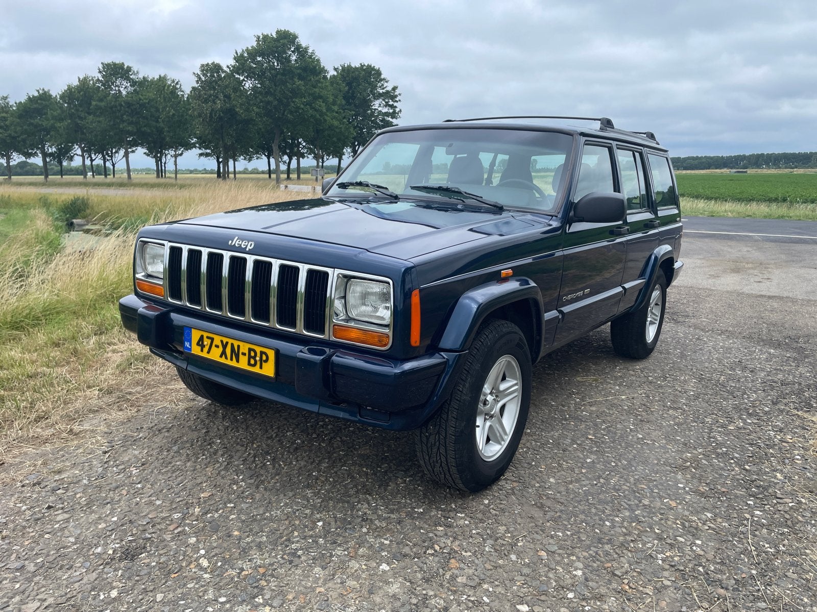Jeep Cherokee 4.0 I AUT 2000 Blauw, Auto's, 4x4, Zwart, Blauw, Leder