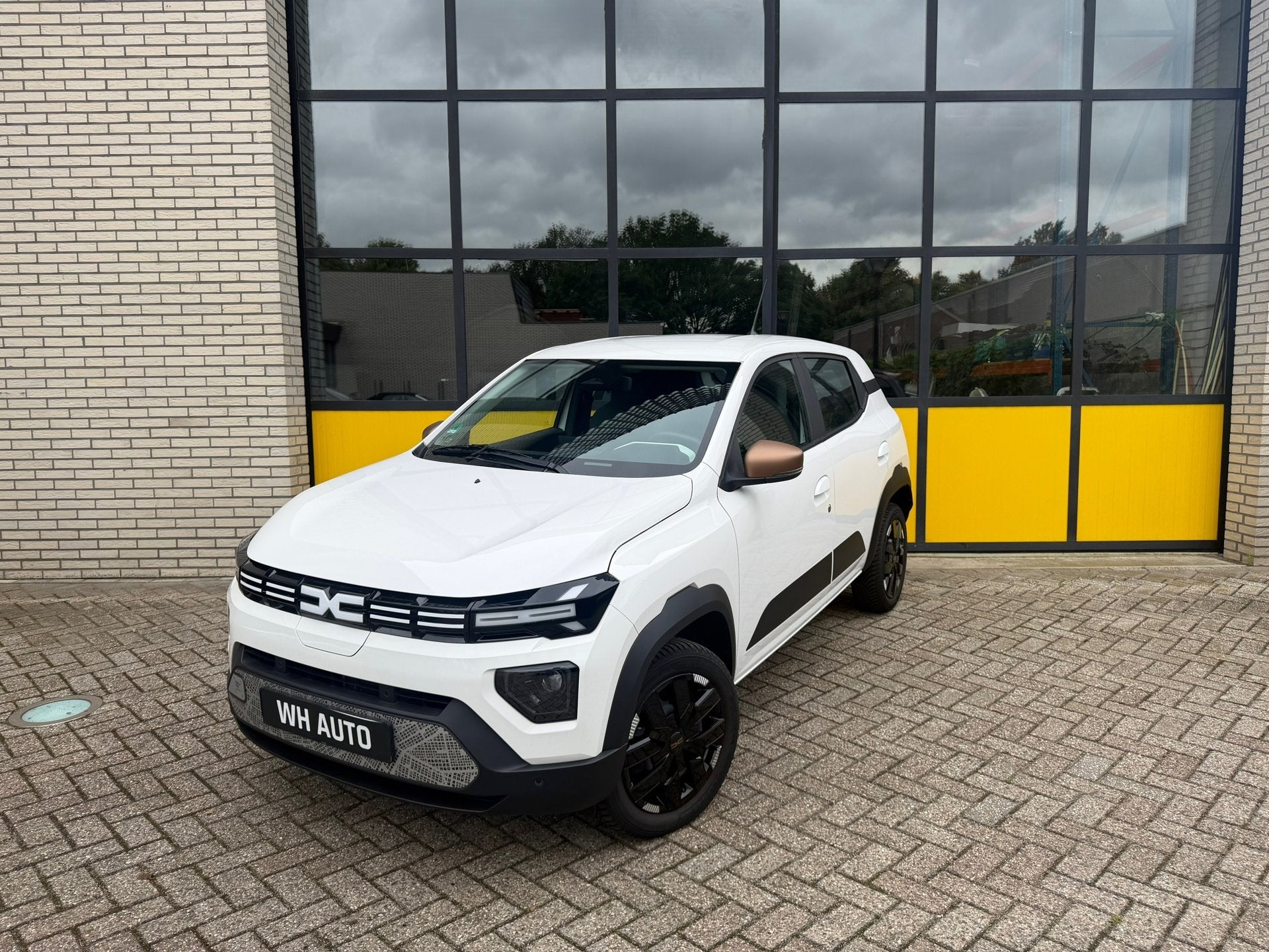 Dacia Spring Extreme 65 26.8 kWh Full Option!, Auto's, Dacia, Stof, Gebruikt, 4 stoelen, Wit