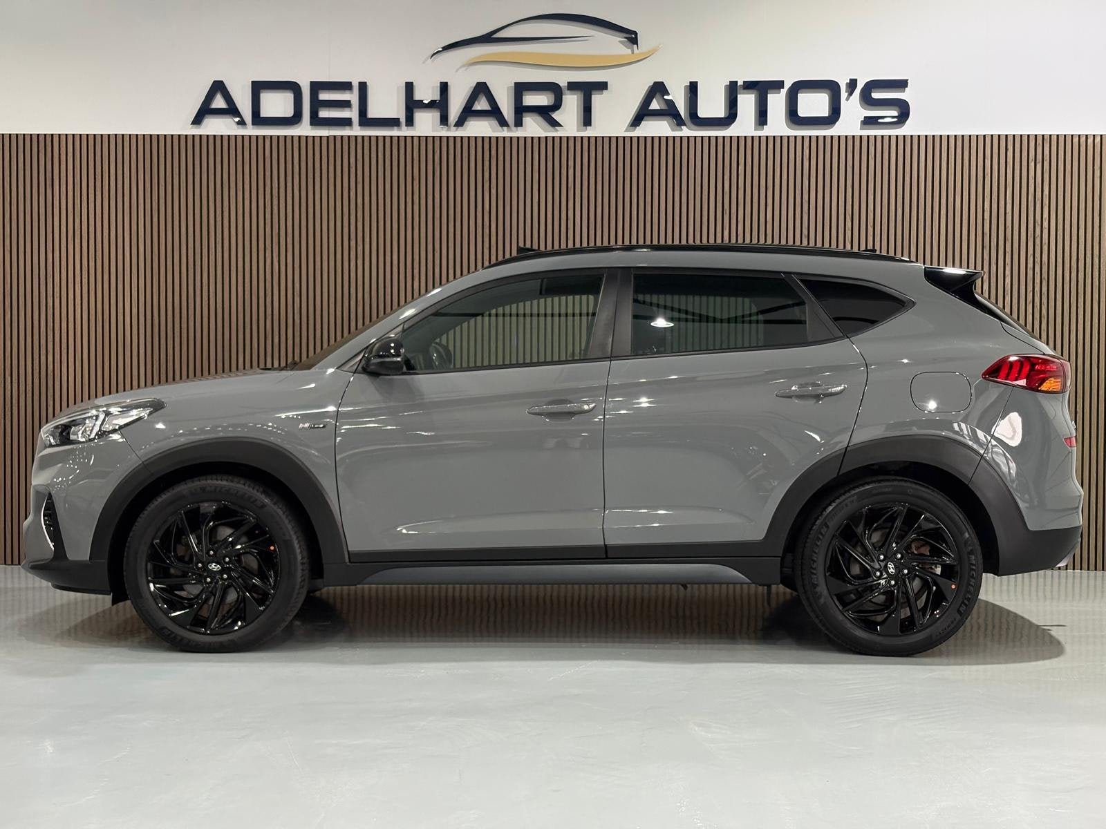 Hyundai Tucson 1.6 T-GDI N-Line Nardo Grey 177 PK automaat P, Auto's, Dealer onderhouden, 15 km/l, Gebruikt, 4 cilinders