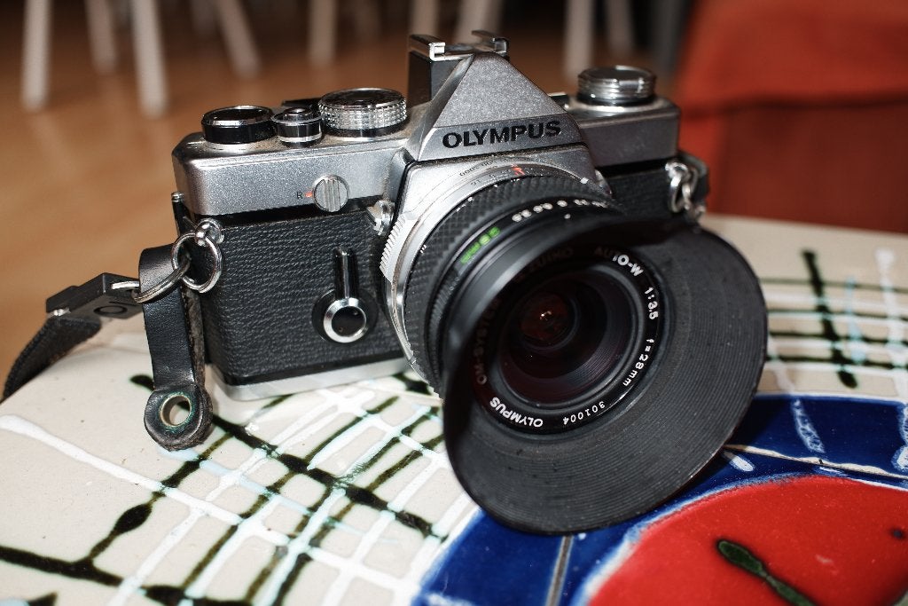 Olympus OM-1 met G.Zuiko Auto-W 1:3.5 f=28mm lens, Ophalen of Verzenden, Gebruikt, Spiegelreflex, Canon