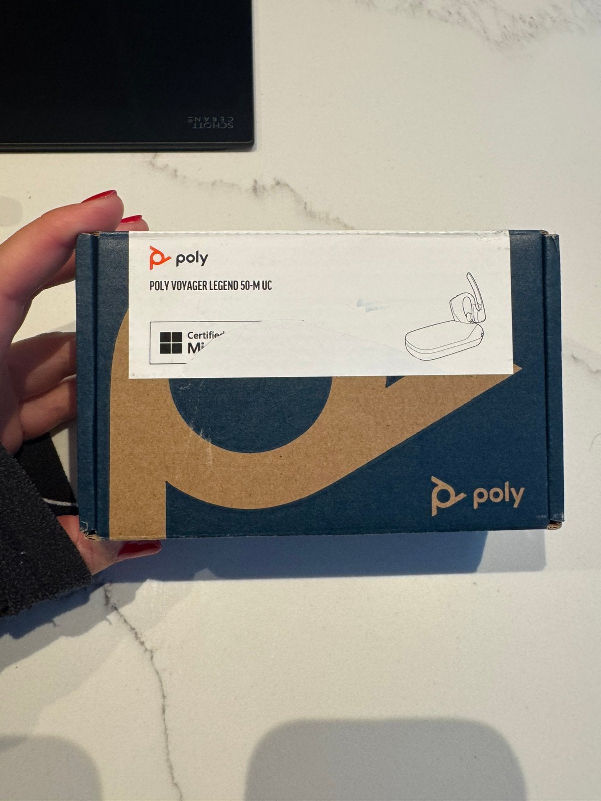 Poly Voyager Legend 50-M UC draadloze headset.