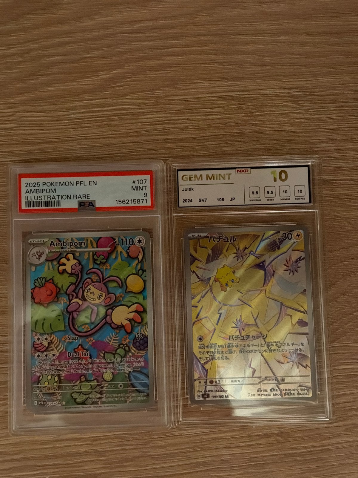 Pokémon Kaarten: Ambipom (PSA 9) en Joltik (NXR 10), Ophalen of Verzenden, Zo goed als nieuw, Losse kaart