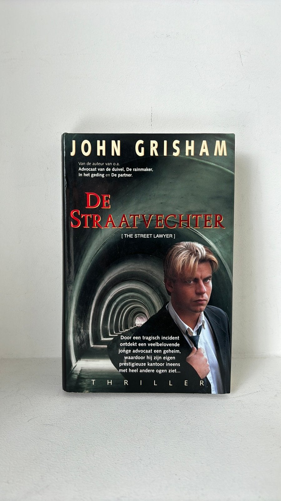 De Straatvechter - John Grisham boek, Ophalen of Verzenden, Zo goed als nieuw