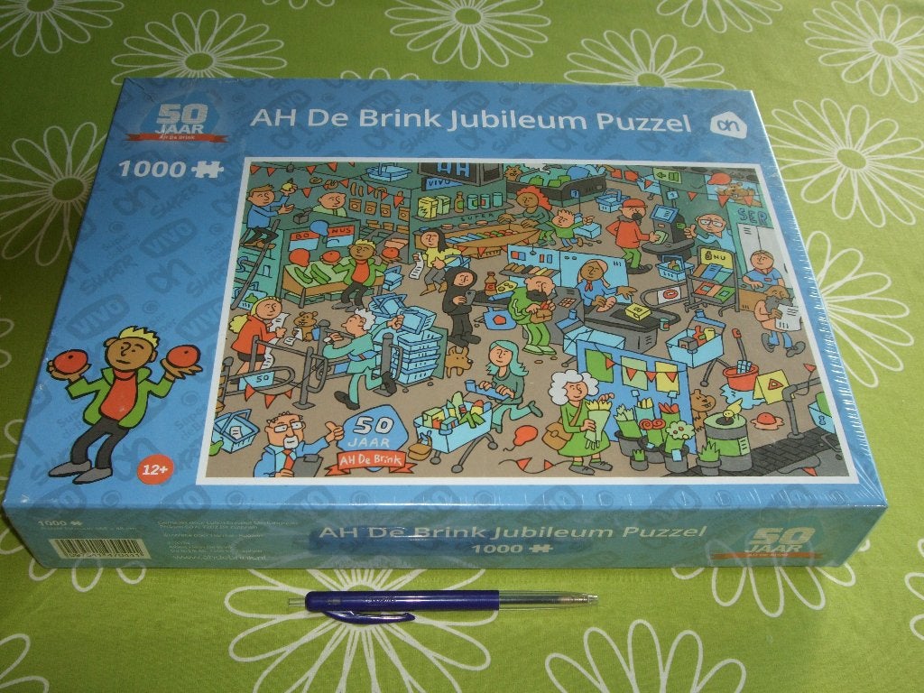 Nieuw in seal: AH de Brink jubileum cartoon puzzel - 1000 st, Ophalen of Verzenden, 500 t/m 1500 stukjes, Nieuw, Legpuzzel