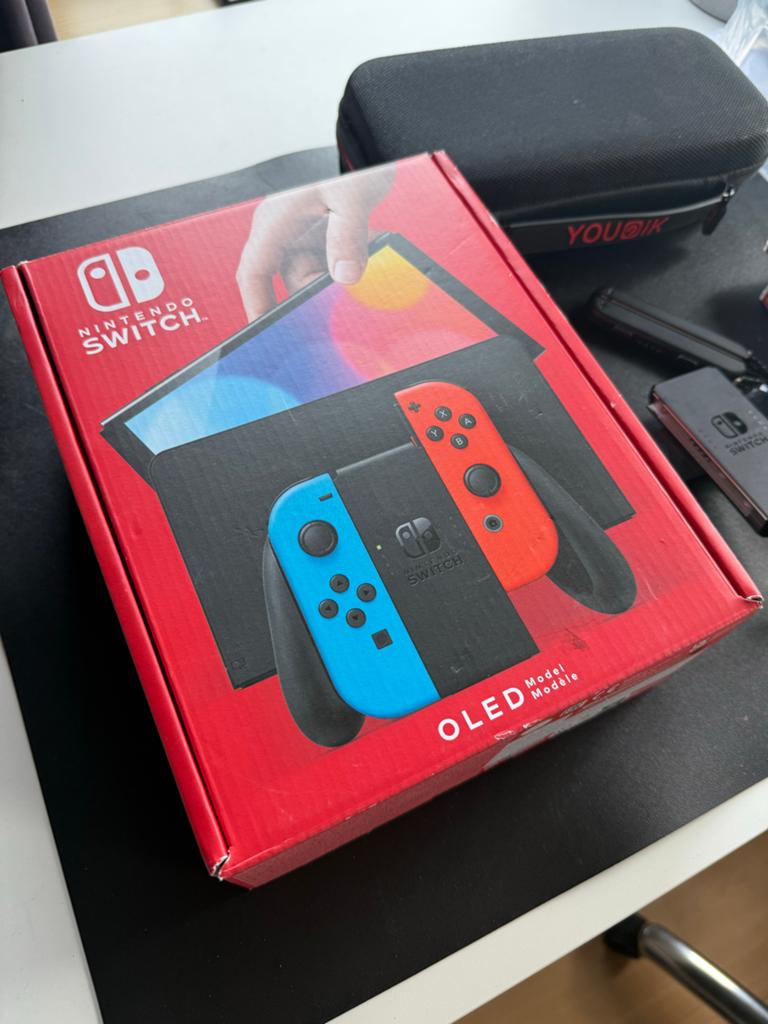 ≥ Nintendo Switch OLED met 4 games, extra controller & koffer