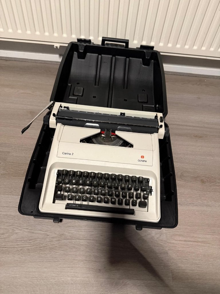 NIEUWSTAAT Typemachine Olympia Carina 2 + Orignele koffer, Diversen, Ophalen of Verzenden, Nieuw