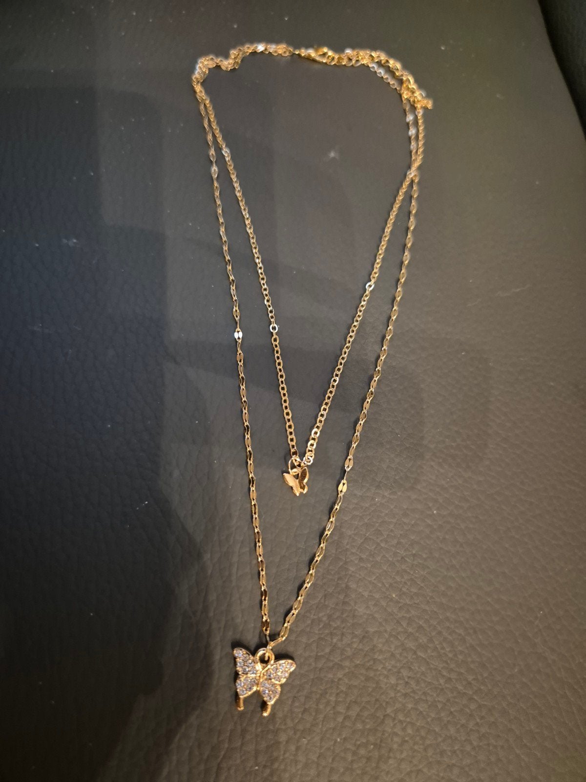 Goudkleurige dubbel ketting met vlinder (nieuw), Overige materialen, Met strass, Nieuw, Ophalen of Verzenden