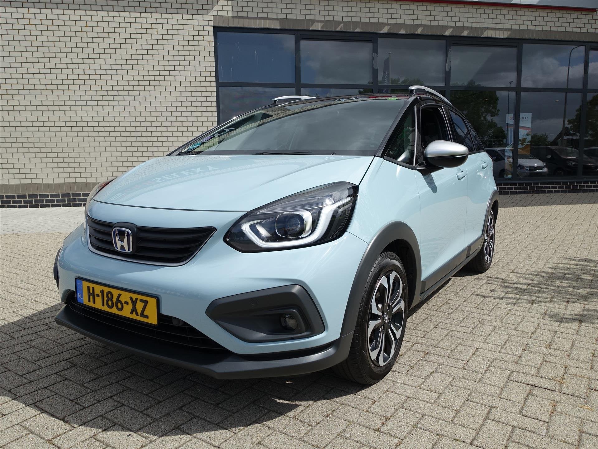 HONDA Jazz 1.5 i-MMD 109pk Hybrid CVT Crosstar Zwart Dak en, Auto's, Honda, Stof, 4 cilinders, Blauw, Bedrijf
