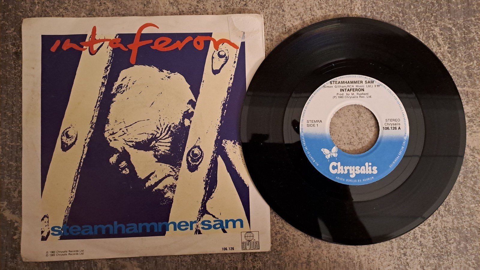 intaferon  - steamhammer sam, Gebruikt, 7 inch, Pop, Fotohoes