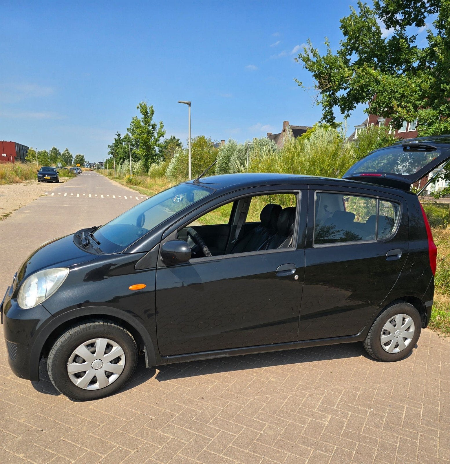 Daihatsu Cuore 1.0 5D AUT 2011 Zwart, Auto's, 600 kg, 18 €/maand, 4 stoelen, Cuore
