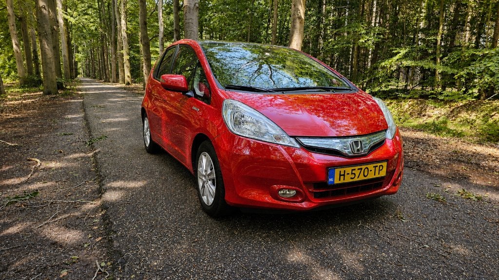Honda Jazz Hybrid 1.4 I-vtec 89pk CVT 2013 Rood trekhaak., Auto's, Honda, Stof, Zwart, 4 cilinders, 1158 kg