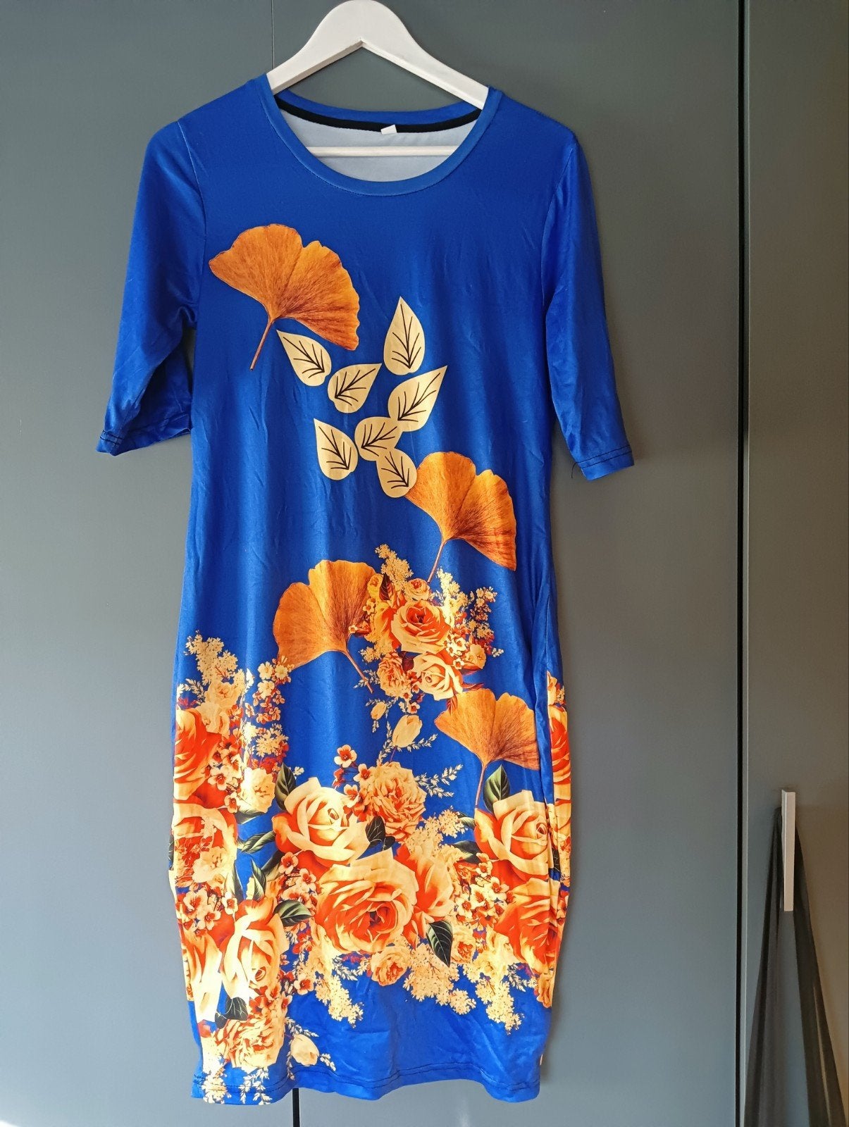 Nieuwe helderblauwe shirtjurk mt L met oranje/gele opdruk, Blauw, Maat 42/44 (L), Nieuw, Ophalen of Verzenden