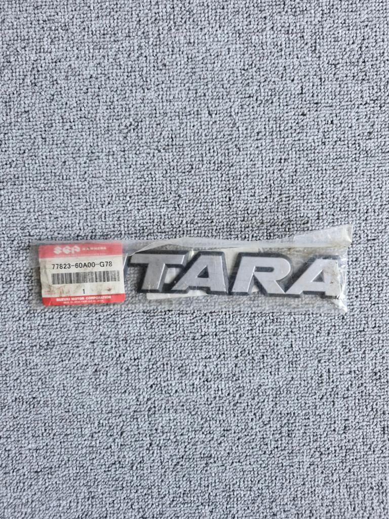 Suzuki Vitara Emblem 77823-60A00-G78 - Origineel Nieuw, Ophalen of Verzenden, Nieuw, Suzuki
