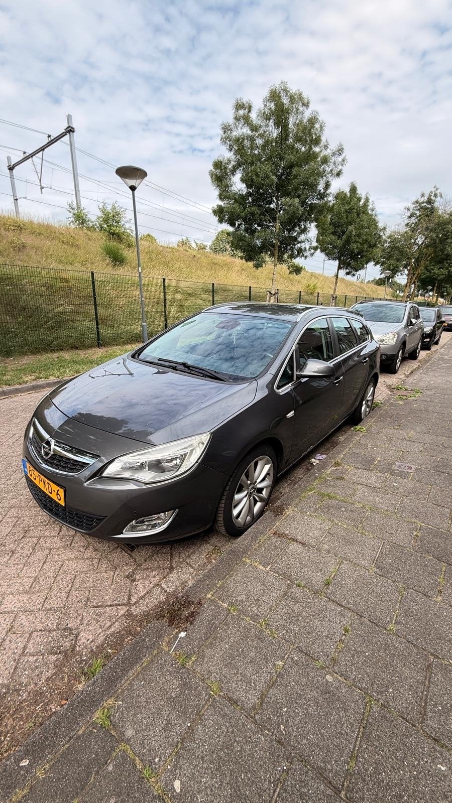 Opel Astra 1.4 Turbo 88KW Sports Tourer 2011 Grijs, Auto's, Voorwielaandrijving, 4 cilinders, 1337 kg, Origineel Nederlands