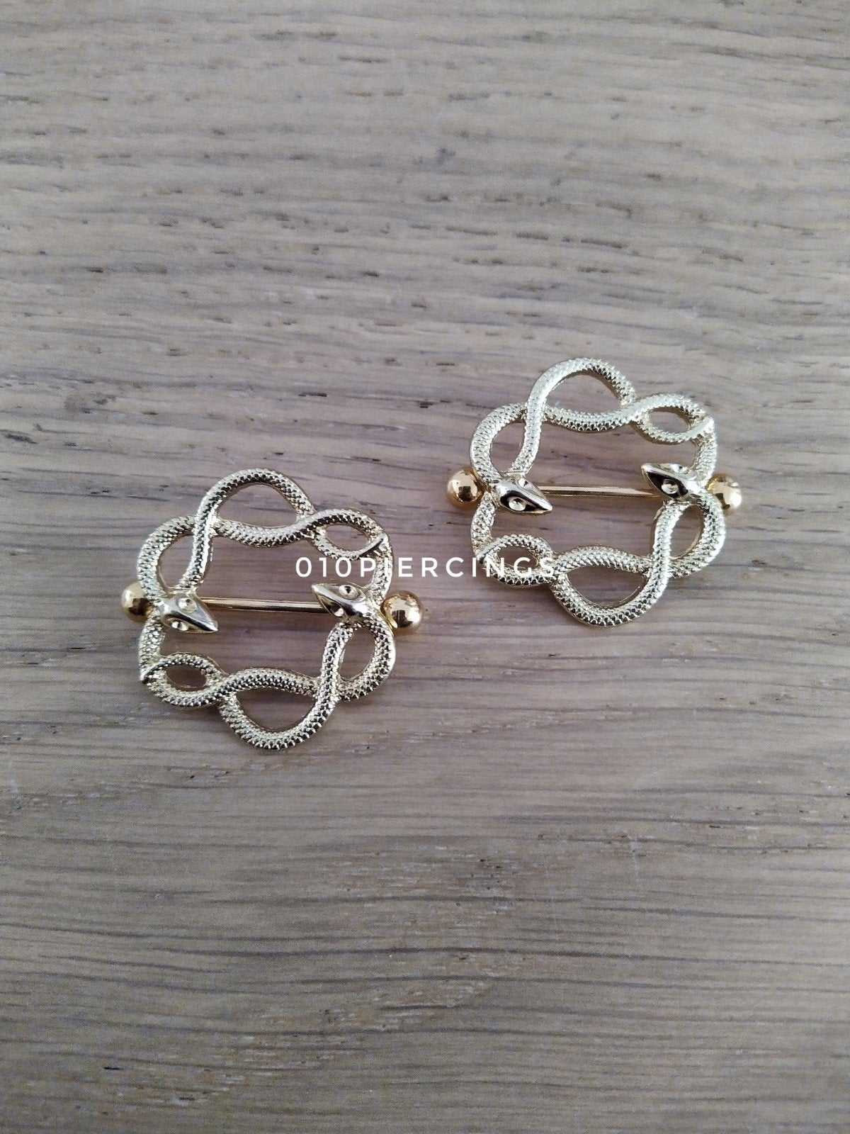Nieuwe tepelpiercing. Slangen. Goud kleur., Ophalen of Verzenden, Zo goed als nieuw, Staal, Oor- of Traguspiercing
