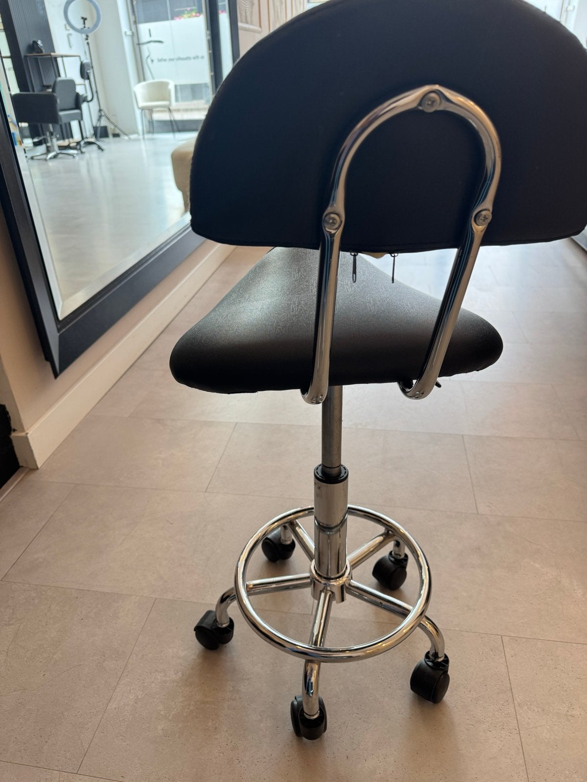 Zwarte ergonomische zadelkruk met rugleuning