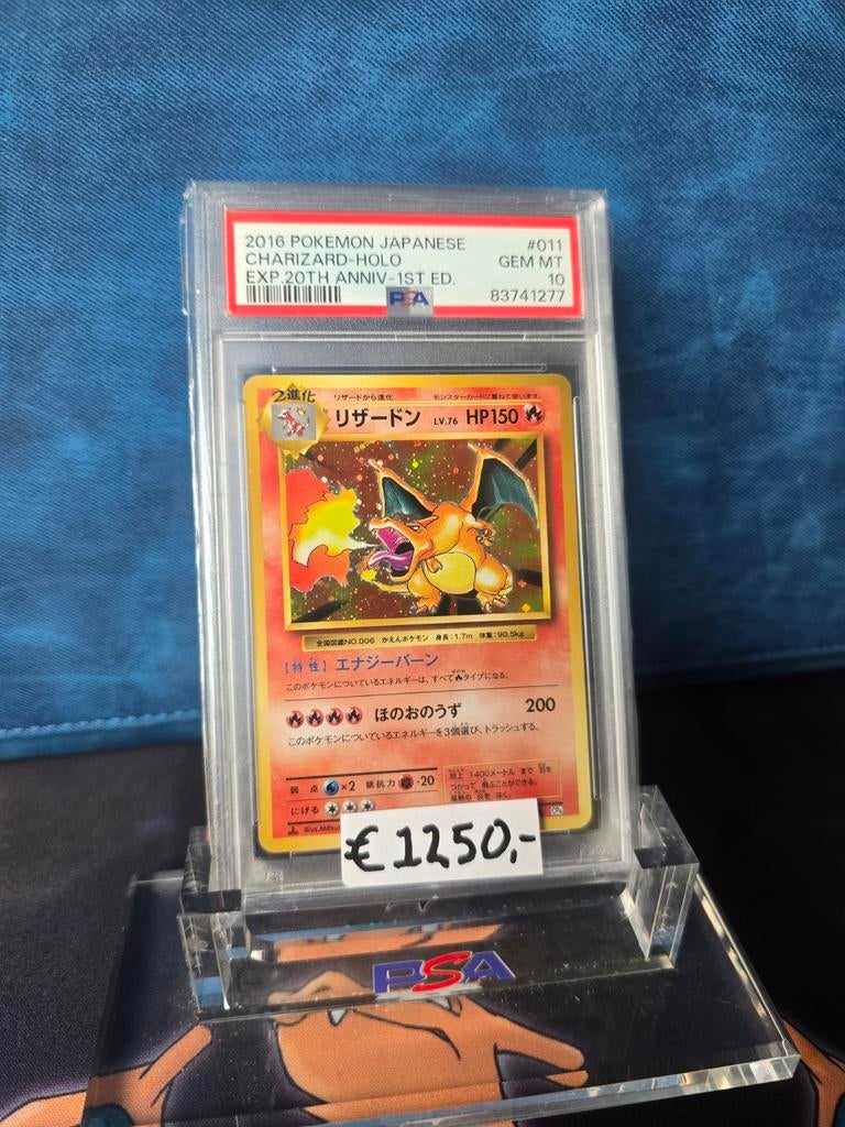 PSA 10 Japanse Charizard Holo 20th Anniv. 1st Ed., Ophalen of Verzenden, Zo goed als nieuw
