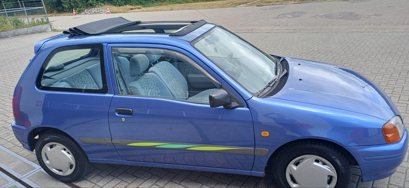 Toyota Starlet 1.3 16V AUT 1997 Blauw, Auto's, Stof, Starlet, Grijs, Particulier