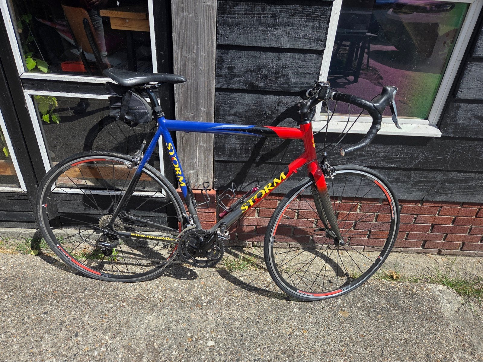 Storm racefiets - Blauw/Rood - Redelijke staat, Fietsen en Brommers, Fietsen | Racefietsen, 28 inch, Gebruikt, Aluminium, 15 tot 20 versnellingen
