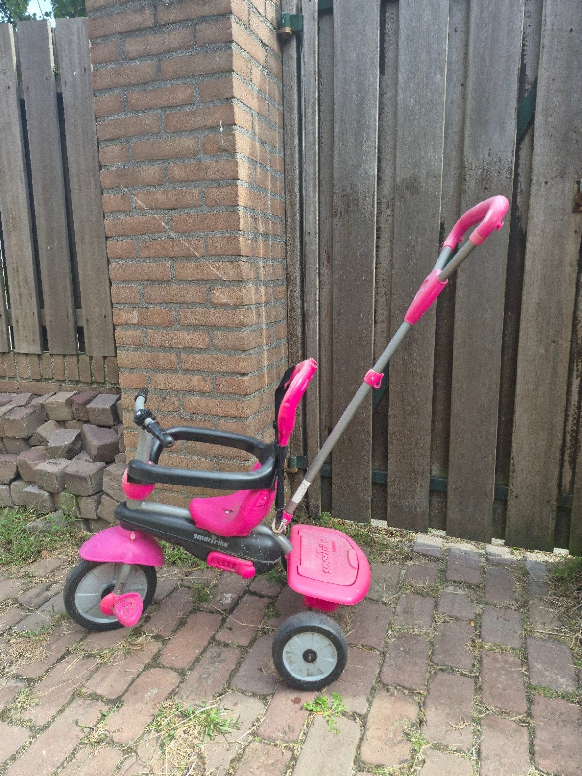 Roze driewieler met duwstang, Ophalen, Gebruikt