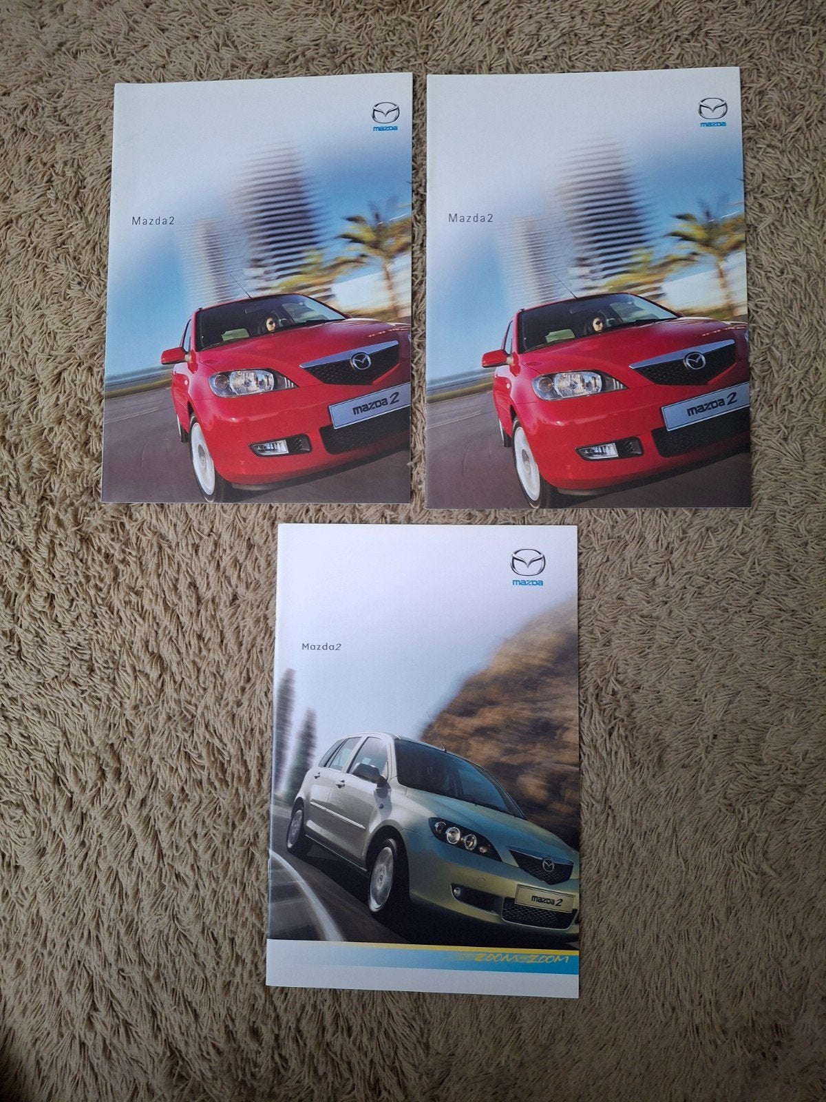 3x autofolder Mazda 2, Verzenden, Zo goed als nieuw, Mazda