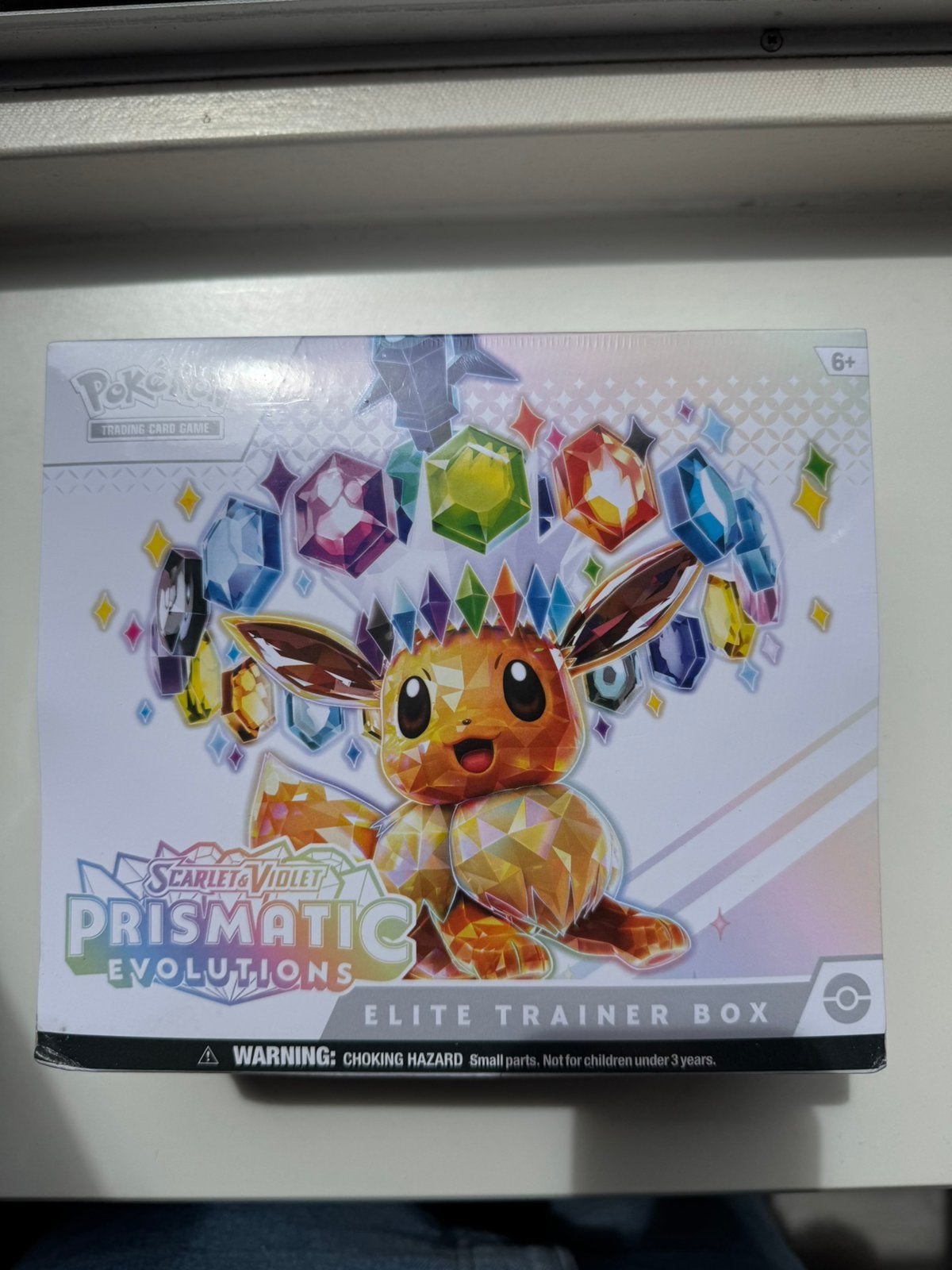 Prismatic Evolutions Elite Trainer Box inclusief acryl, Ophalen of Verzenden, Nieuw, Overige typen, Foil