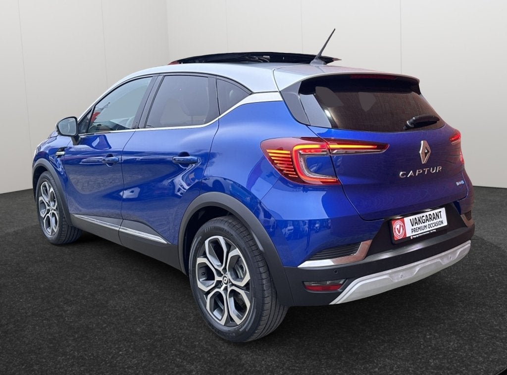 Renault Captur 1.6 E-Tech Hybride 145 Intens Panorama Schuif, Auto's, Gebruikt, Blauw, Leder en Stof, Bedrijf