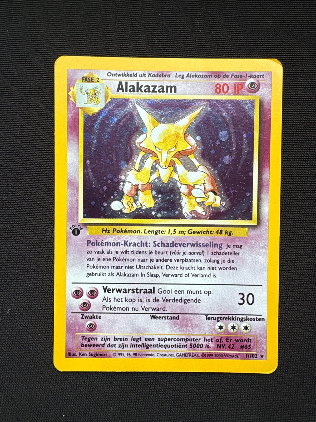Alakazam 1/102 Base Set Holo NL - 1e editie - EXC, Hobby en Vrije tijd, Ophalen of Verzenden, Zo goed als nieuw, Losse kaart, Foil
