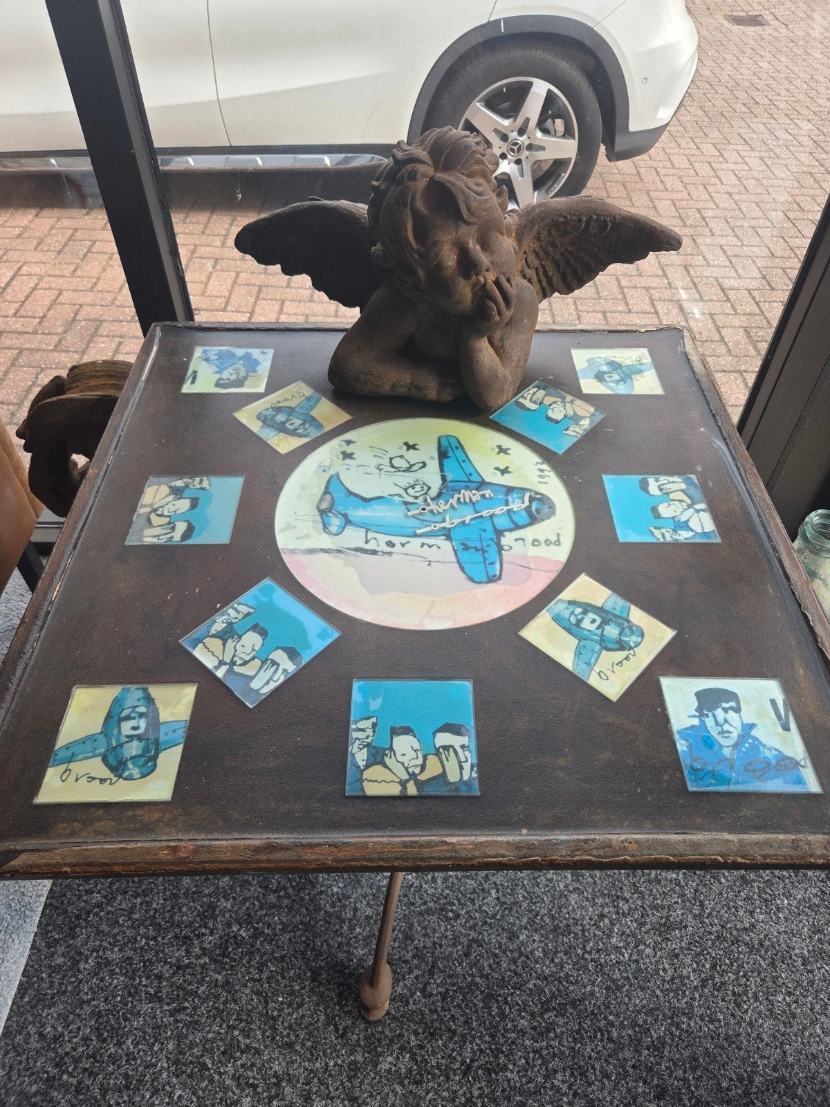 Unieke Herman Brood terrastafel, 90x90 cm, gietijzer, Ophalen, Gebruikt, Metaal of Aluminium, Vierkant