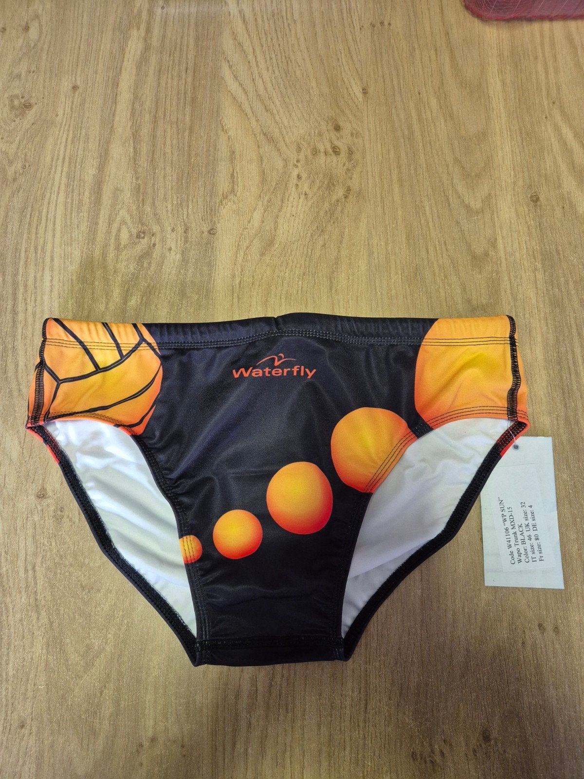 Waterfly Waterpolozwembroek - Zwart met oranje/gele print, Ophalen of Verzenden, Zwart, Waterfly, Zwemslip