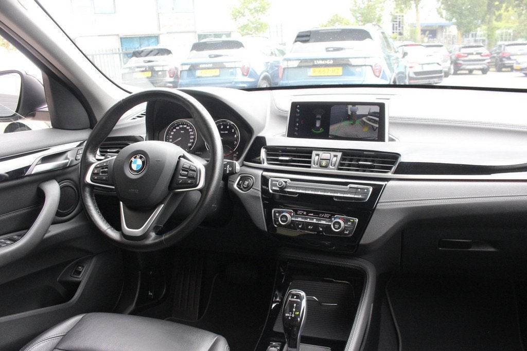BMW X1 1.8i sDrive xLine | Camera | ACC |, Gebruikt, Zwart, Bruin, Leder en Stof