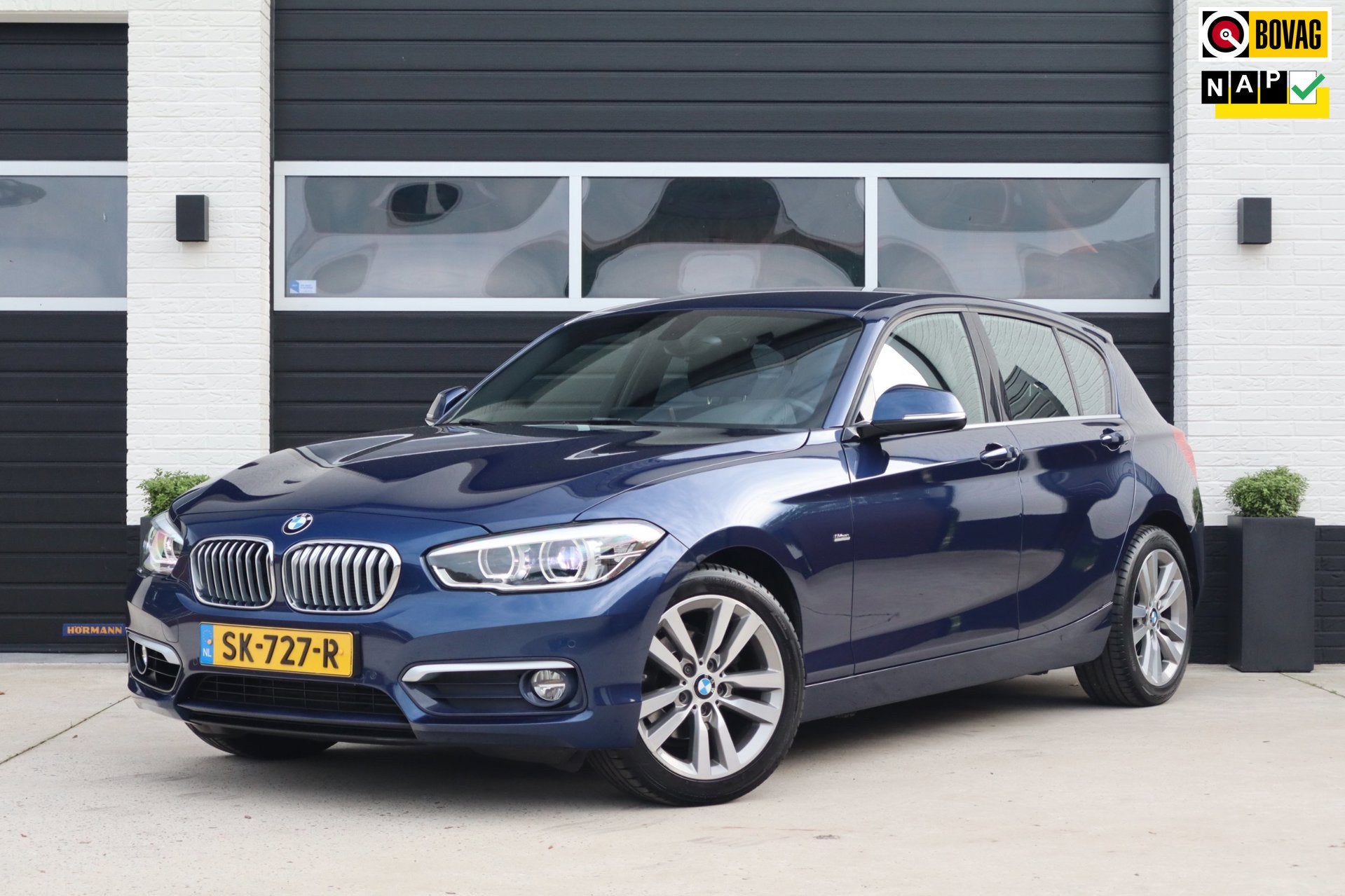 BMW 1-serie 118i 136pk High Executive Urban line - Leder - L, Gebruikt, Blauw, Parkeerassistent, Bedrijf