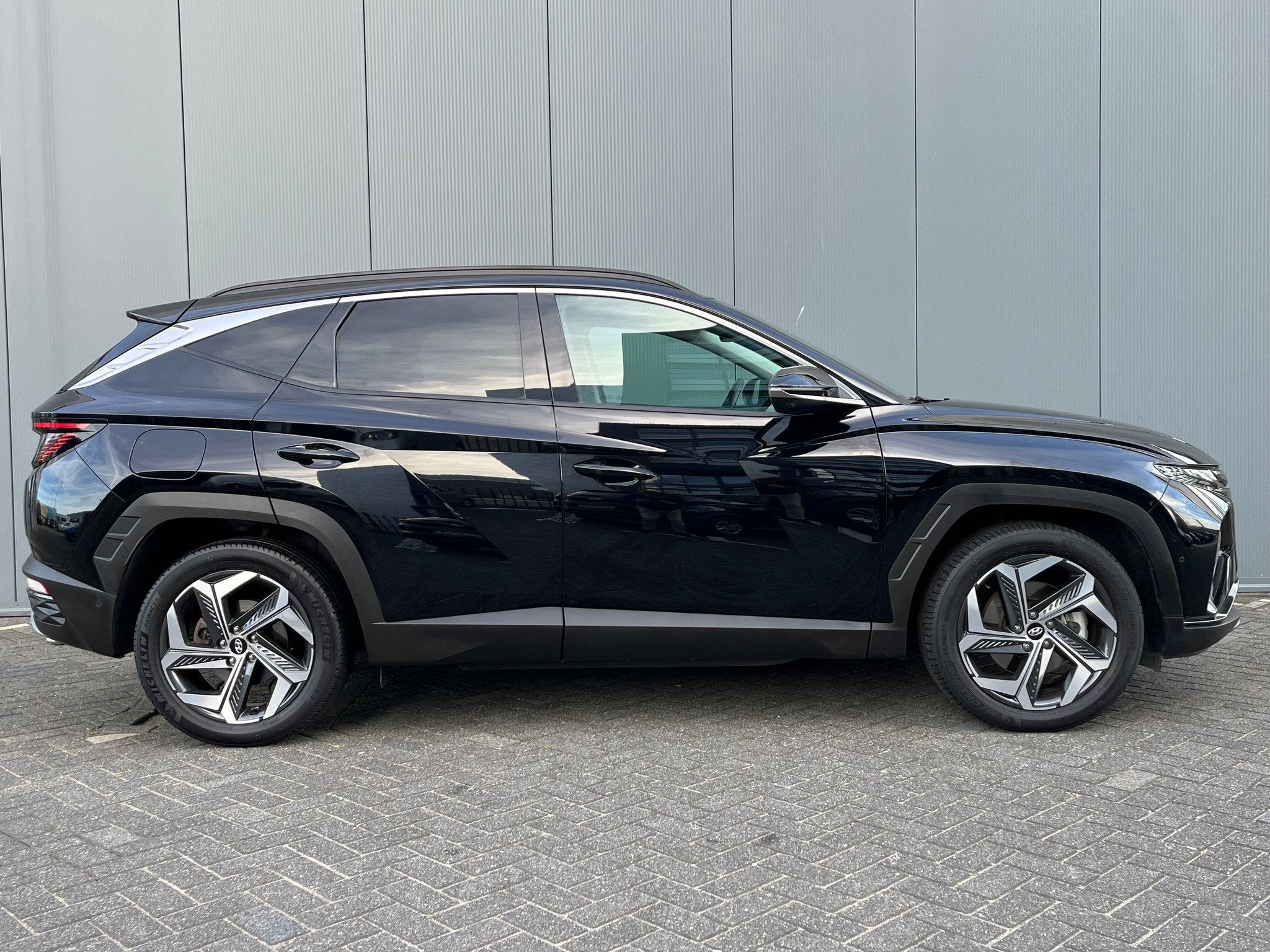 Hyundai Tucson 1.6 T-GDI 265pk PHEV Premium 4WD, Auto's, Gebruikt, 4 cilinders, Zwart, Bedrijf