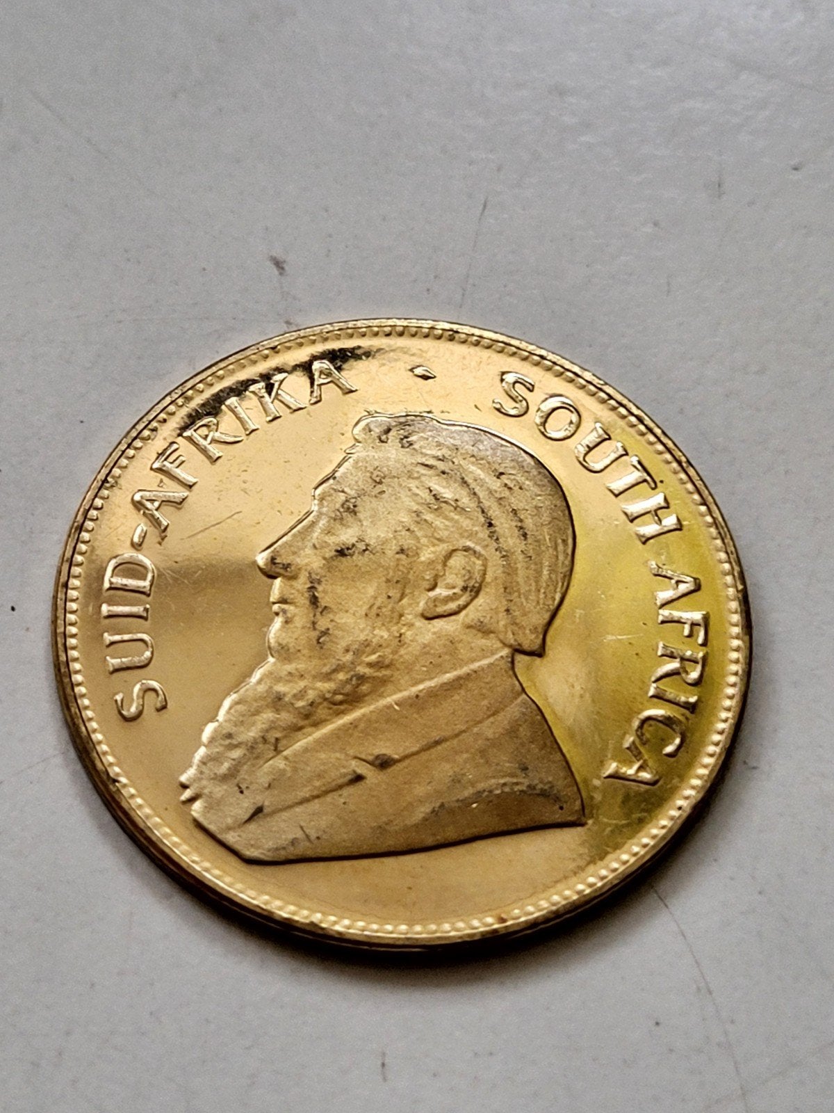 Penning goudkleurig Zuid-Afrikaanse munt met Paul Kruger, Ophalen of Verzenden