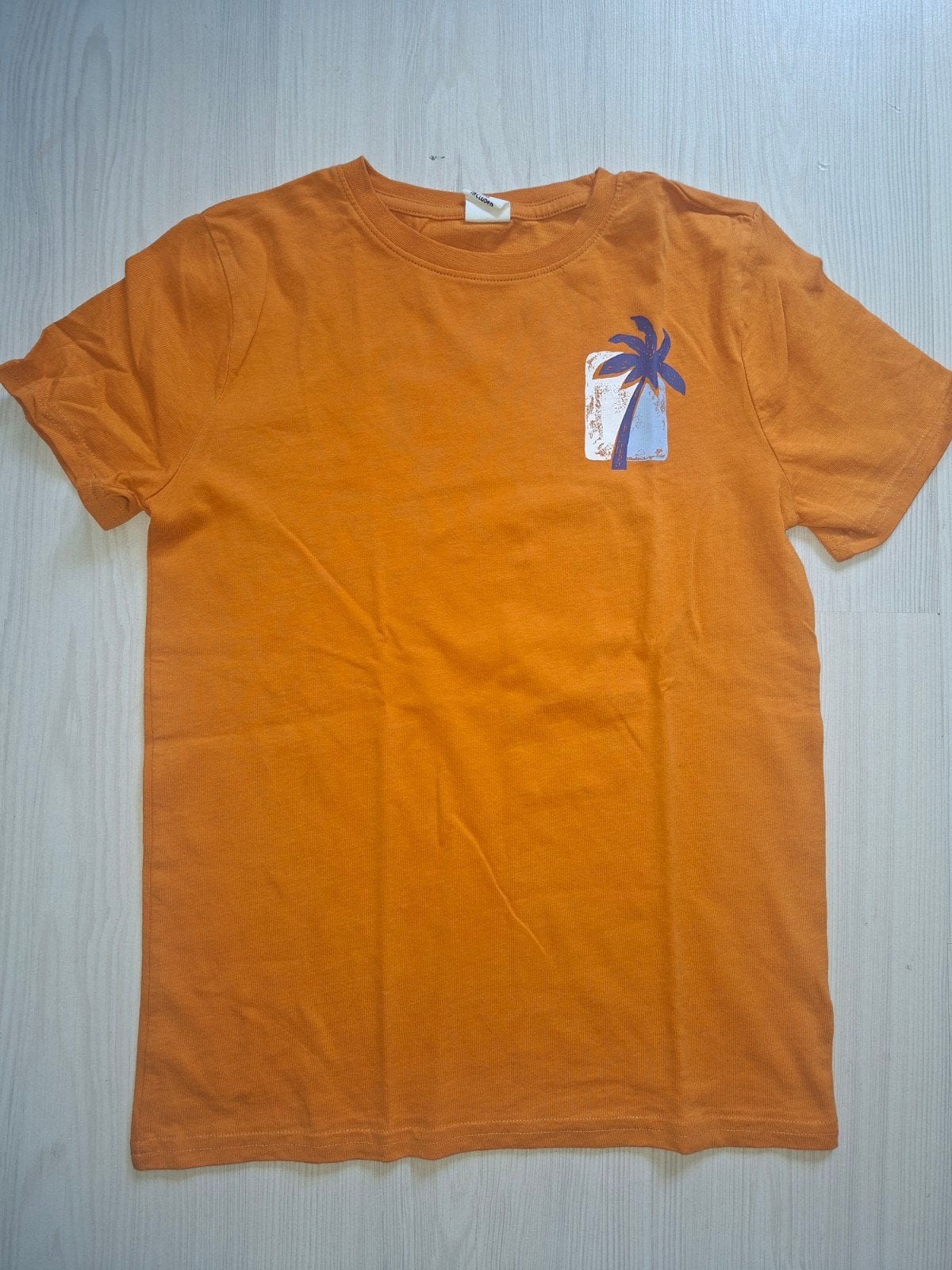 Hema T-shirt oranje met palmboom, maat 134/140, Jongen of Meisje, Nieuw, Ophalen of Verzenden, Shirt of Longsleeve