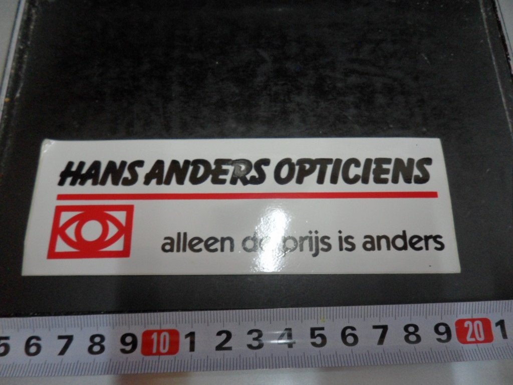 sticker Hans Anders Opticiens Alleen de prijs is anders *, Ophalen, Zo goed als nieuw