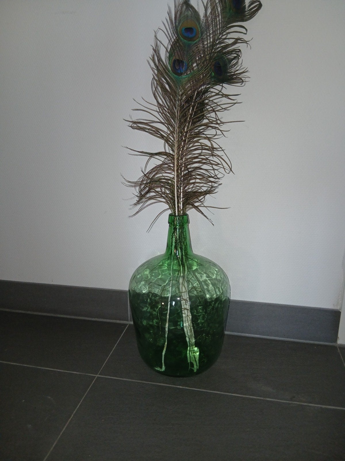 Grote groene glazen fles met pauwenveren, Ophalen