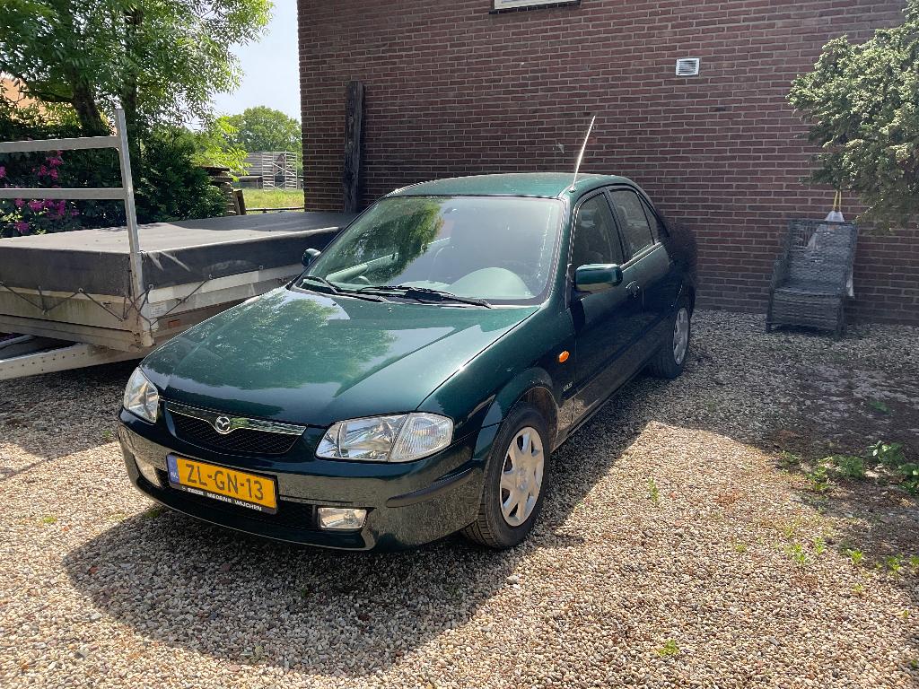 Mazda 323 1.5 SDN LX 1999 Groen, Auto's, 4 cilinders, 400 kg, Origineel Nederlands, 1200 kg