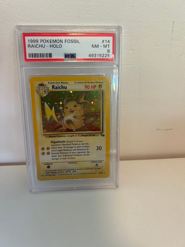 Pokémon Raichu Holo #14 Fossil 1999 PSA 8 – Vintage, Ophalen of Verzenden, Zo goed als nieuw, Losse kaart