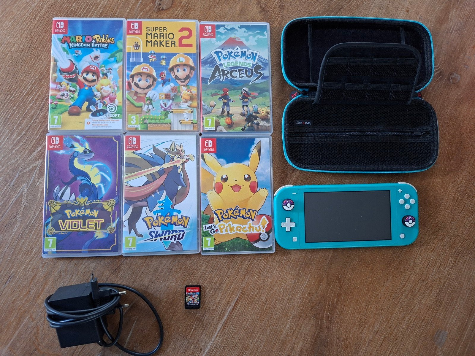 Nintendo Switch Lite Turquoise met 7 games en hoes, Ophalen, Met games, Zo goed als nieuw, Switch Original