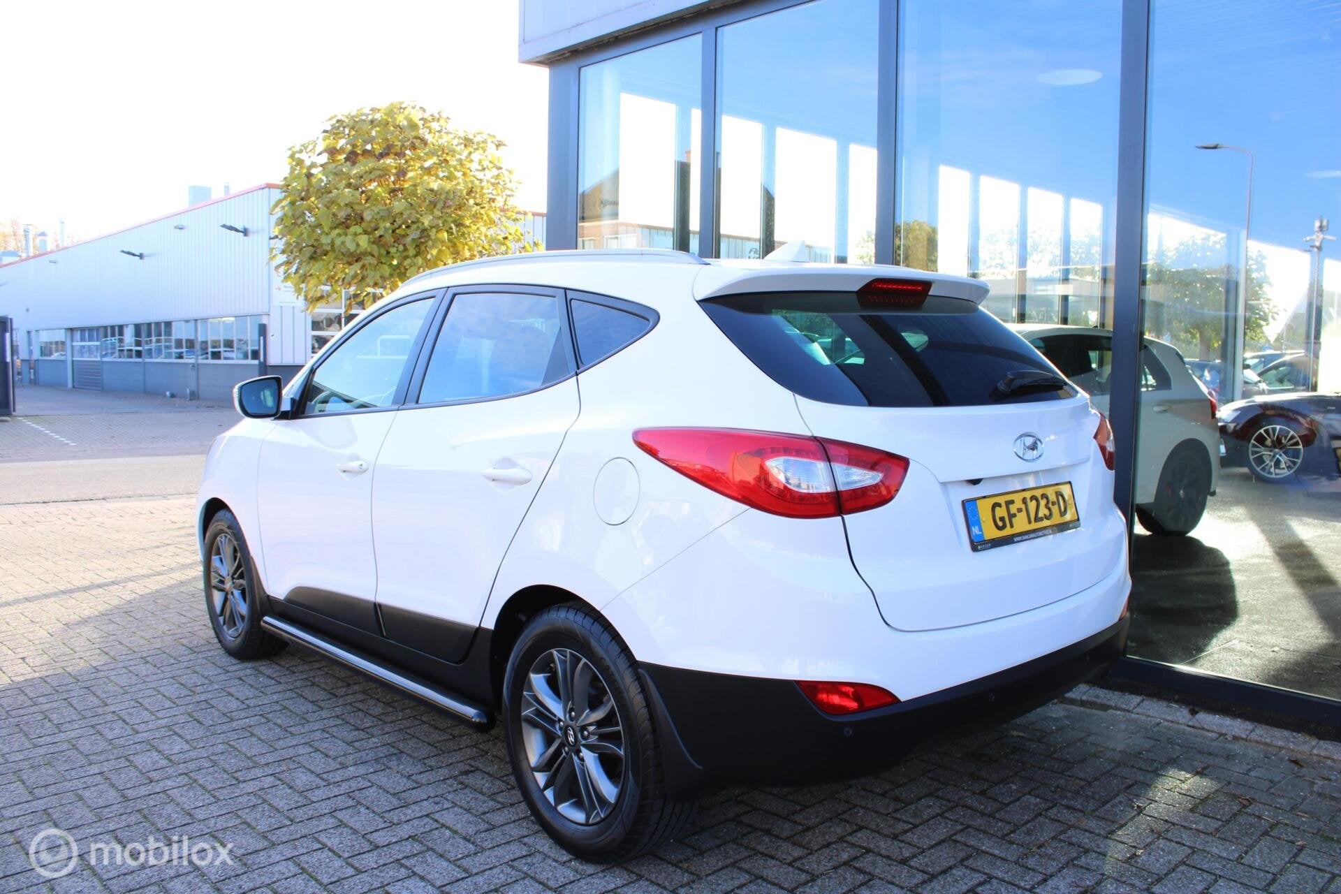 Hyundai ix35 1.6i GDI Go! Camera|Navi|Half-leder|NL-Auto, Auto's, Voorwielaandrijving, Euro 5, 4 cilinders, Wit