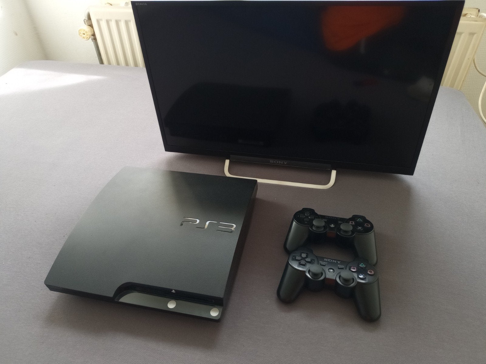 PlayStation 3 met tv, Met 2 controllers, Slim, Gebruikt, Met games