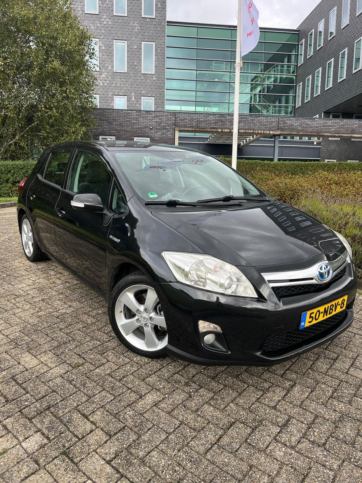 Toyota Auris 1.8 Full Hybrid 5DR CVT 2010 Zwart, Zwart, 4 cilinders, Leder en Stof, Zwart