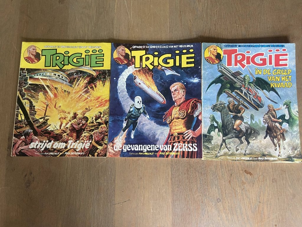 Trigie, Gelezen, Don Lawrence, Mike Butterworth, Ophalen of Verzenden, Meerdere stripboeken