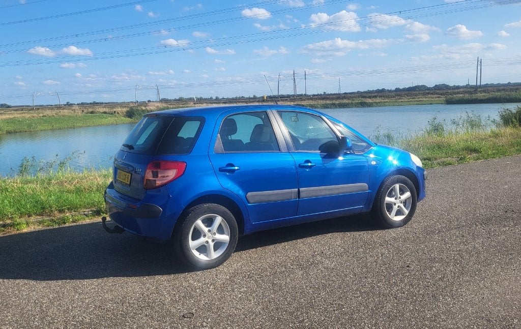 Suzuki SX4 1.6 2009 Blauw - Trekhaak - 213.481km, Auto's, Voorwielaandrijving, 15 km/l, 4 cilinders, Origineel Nederlands